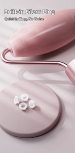 Detail of pink facial roller with rose gold frame and built-in silent plug for noise reduction