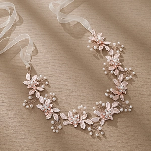 Detail of rose gold bridal headband featuring alloy leaves with pearls and rhinestones