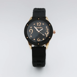 Close-up of black dial with gold heart detail and leather strap on retro quartz watch