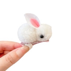 Cute white plush bunny hair clip for girls featuring soft pink ears and metal grip