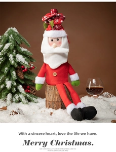 Detail of Santa Claus wine bottle cover with knit hat and beard for Christmas table decor
