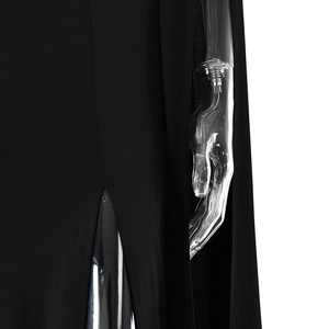 Detail view of black dress featuring high side slit and elegant cape-style sleeves