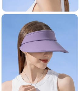 Detail of purple wide brim sun visor hat for women against a clear blue sky background