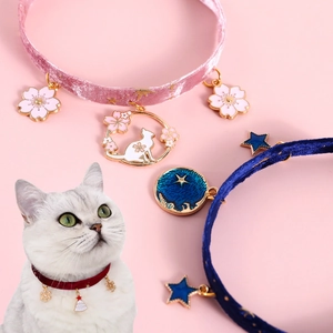 Detailed view of adjustable velvet pet collars with gold stars and fish charms in multi colors