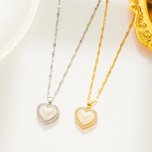 Close-up of gold and silver titanium necklaces with pearly heart pendants and tiny crystals