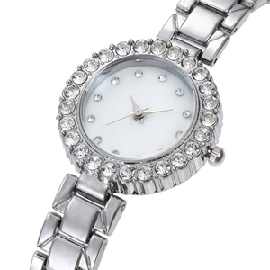 Detail of silver ladies watch featuring a rhinestone bezel and minimalist white dial