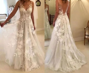 Detailed front and back view of a white V-neck lace wedding dress with open back and floral appliques