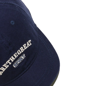 Detailed close-up of premium 3D embroidery and stitching on navy blue baseball cap
