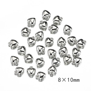 Macro view of 8x10mm silver heart pendants for DIY jewelry with metallic finish