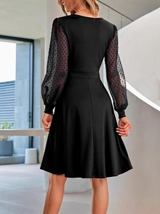 Chic black V-neck dress with polka dot sheer mesh sleeves and an A-line silhouette
