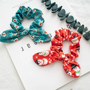 Detail of Christmas scrunchies with reindeer and snowman patterns on a magazine