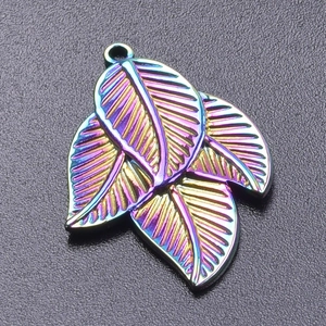 Macro detail of iridescent 18k gold plated leaf pendant with vibrant multi-color reflection
