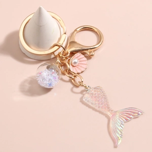 Close-up of ocean mermaid keychain with gradient resin tail and pearl shell charm