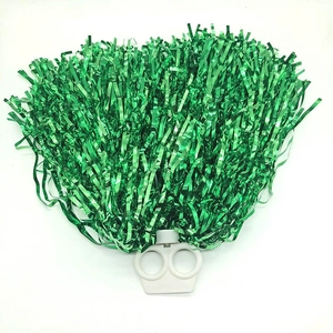 Detail of green cheerleader pom pom with metallic foil and white plastic handle