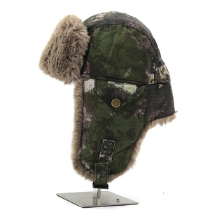Detail of winter trapper hat with camouflage fabric and soft brown faux fur lining