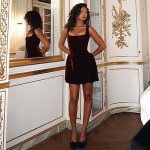 Detailed shot of burgundy velvet sleeveless mini dress with square neck in a retro palace room