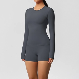 Detail of charcoal grey long-sleeved yoga top and high-waist shorts set for women