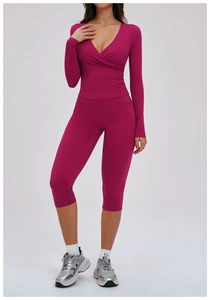 Detail of rose red yoga set with cross wrap long sleeve top and high waist leggings