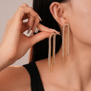 Elegant gold U-shaped tassel earrings with pavé zircons for a luxury evening look