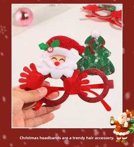 Close-up of festive red glitter Christmas glasses with Santa and green tree decorations