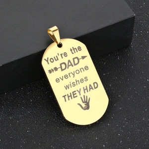 Macro view of golden stainless steel dog tag pendant with laser engraved quote for Dad