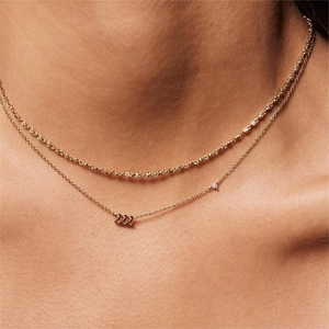 Detail of gold titanium steel necklace with 222 angel number pendant and small diamond accent
