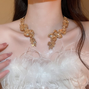 Champagne teardrop crystal necklace with amber tones on a model from 45 degree angle