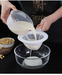 Fine nylon mesh strainer filtering fresh soy milk with a durable white plastic frame