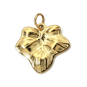 Macro view of gold metal leaf pendant with detailed vein texture and polished finish