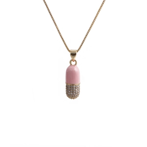 Macro view of a pink and gold pill pendant featuring micro-set zircon on a box chain