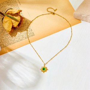 Golden stainless steel necklace with green malachite stone in an eight-pointed star pendant