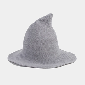 Close-up of light gray knitted wizard hat featuring detailed stitching and a curved top