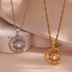 Detail of sun and moon eye pendants with sparkling rhinestones in gold and silver