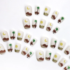 Press-on nail set featuring matte desert patterns with moon and palm tree designs