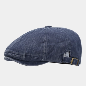 Detail view of washed denim flat cap with adjustable side metal buckle in navy blue