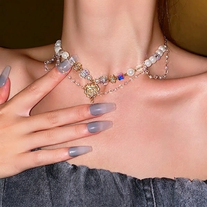 Double-layered pearl and crystal heart necklace with vintage gold-tone pendant for women