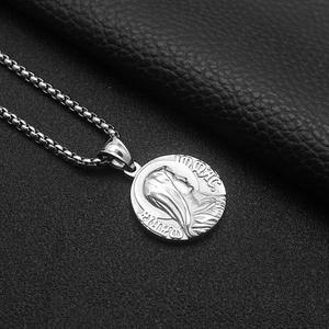 Macro shot of silver vintage Greek myth coin pendant with embossed portrait and box chain