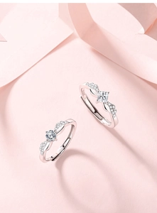 Detailed macro of S925 sterling silver angel wing rings with sparkling square and round stones