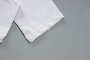 Macro detail of high-quality double-needle stitching on white yoga jumpsuit hem