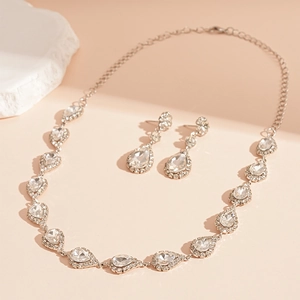 Close-up of sparkling teardrop-shaped crystal necklace and earring bridal jewelry set