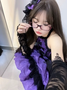 Detail of gothic lolita purple dress with black lace trim and matching headpiece accessories