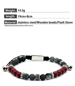 Detail view of ethnic beaded bracelet with red wood beads, flash stones, and steel links