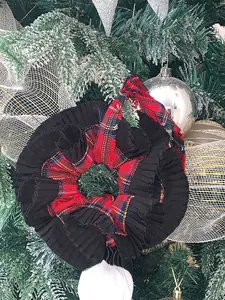 Detail of a large checkered scrunchie with pleated black fabric on a Christmas tree