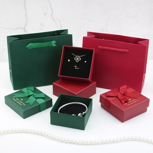 Green and wine red jewelry gift boxes with silk bows and matching paper carry bags