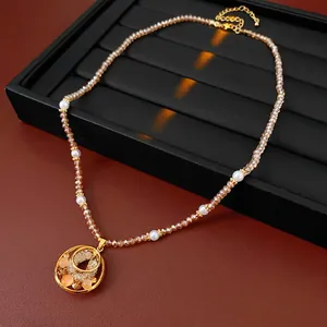 Vintage opal pendant necklace with champagne beads and pearls on black display