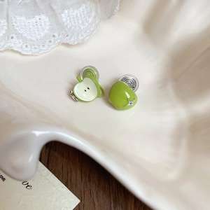 Detail of green apple-shaped enamel stud earrings with silver leaf and zircon accents