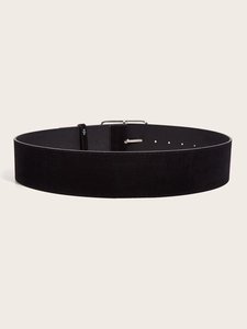 Detail of a vintage black velvet wide belt featuring a minimalist silver metal buckle