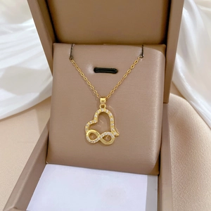 Elegant gold infinity heart necklace with crystal inlay presented in a luxury jewelry box