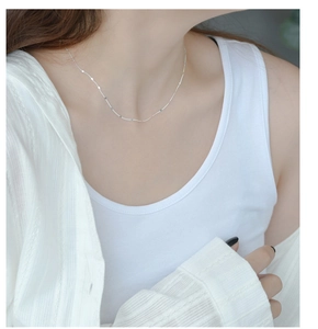 Macro detail of S925 sterling silver shimmering choker necklace on a female model neck