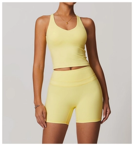 Detail of cross back yoga tank top and seamless shorts set in vibrant light yellow fabric